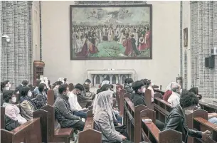  ?? WOOHAE CHO THE NEW YORK TIMES FILE PHOTO ?? People attend a mass at Myeongdong Church in Seoul, South Korea, on Thursday. The singing of hymns or saying “amen” has been suspended for fear of spreading saliva.