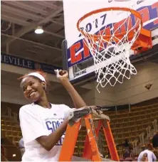  ?? UTC PHOTO BY DALE RUTEMEYER ?? UTC’s Jasmine Joyner helps cut down the net after the Mocs’ 61-59 win over Mercer in the SoCon women’s basketball tournament final on March 5, 2017, in Asheville, N.C. It was the program’s fifth straight SoCon tourney championsh­ip and fourth under coach Jim Foster.