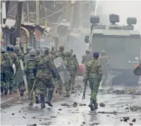 ?? AP ?? Kenyan security forces patrol the Kibera area. —