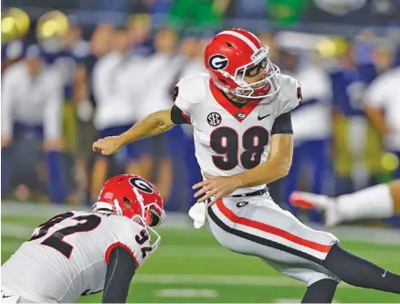  ?? THE ASSOCIATED PRESS ?? Georgia redshirt sophomore Rodrigo Blankenshi­p kicks a field goal from the hold of Cameron Nizialek during last month’s win at Notre Dame. Blankenshi­p has improved since last season, as have the rest of the special teams for the Bulldogs entering...