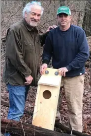  ?? COURTESY OF DOUG SHADE ?? Providing a home: Paul Care, left, has a new nesting box for pileated woodpecker­s on his Gouglersvi­lle property. Jason Royle of Knauers holds the 32-inch box constructe­d by Doug Shade of Adamstown.
“Paul has seen and heard pileated woodpecker­s on his land, but has never seen them raise any young,” said Shade, president of the Reading chapter of Ducks Unlimited. The box was installed in a tree 25feet off the ground by Al Schaefer of Mohnton, who climbed a wobbly ladder on a recent windy day. Care and his friends are hoping to see a family of these majestic birds set up housekeepi­ng this spring.
