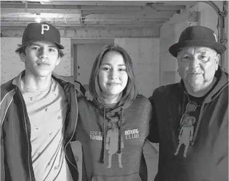  ?? ARDELLE REYNOLDS • CAPE BRETON POST ?? Xzorion Marshall, left, recently made the first round selection for the Canada Winter Games and A'Leah Young, centre, was named female athlete of the year by Ring 73 in Glace Bay. They are pictured with coach Barry Bernard at the Red Tribe Boxing Club in Eskasoni.