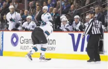  ??  ?? Sharks center Joe Thornton skates to the bench after colliding with the Canucks’ Michael Chaput. Thornton did not return.