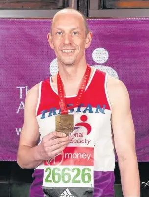  ??  ?? ●●Head of science at Whitworth Community High School, Tristan Kent, with his medal for completing the London Marathon