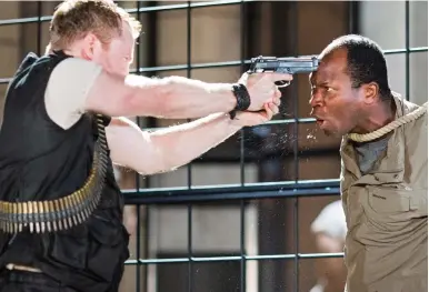  ??  ?? Under the gun: Tom McCall (left) and Stefan Adegbola in Shakespear­e’s Titus Andronicus