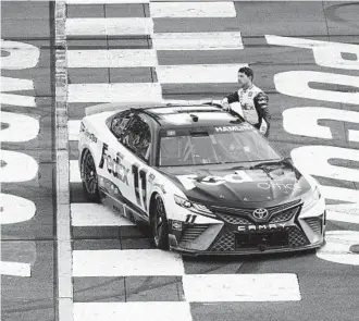  ?? MATT SLOCUM AP ?? Denny Hamlin got the checkered flag at Pocono, but he was first NASCAR driver DQ'd since 1960.