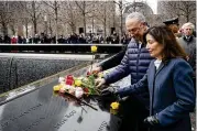  ?? JOHN MINCHILLO / AP ?? Senate Majority Leader Chuck Schumer, D-new York, and New York Gov. Kathy Hochul place flowers during a ceremony Sunday marking the 30th anniversar­y of the bombing at the World Trade Center.