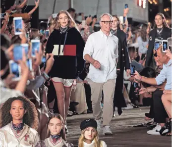  ?? RANDY BROOKE, GETTY IMAGES FOR TOMMY HILFIGER ?? Hadid took her runway bow with Hilfiger in a sweatshirt that updated the brand's signature color-block logo.