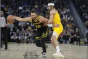  ?? JEFF CHIU — THE ASSOCIATED PRESS ?? Golden State Warriors guard Stephen Curry (30) drives to the basket against Indiana Pacers guard Andrew Nembhard in San Francisco on Friday, March 22.