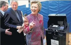  ?? REUTERS ?? Democratic presidenti­al candidate Hillary Clinton casts her ballot in the New York presidenti­al primary election as her husband, former US president Bill Clinton looks on.