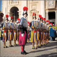  ?? AP/ANDREW MEDICHINI ?? Vatican Swiss Guards stand at attention in front of St. Peter’s Basilica at the Vatican before the arrival of Pope Francis to celebrate Easter Mass on Sunday.