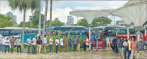  ??  ?? Migrant workers line up outside the Ferris wheel attraction in Singapore.