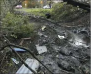  ?? AP PHOTO/ HANS PENNINK ?? Debris is scattered over an area Sunday at the site of Saturday’s fatal crash Schoharie, N.Y.