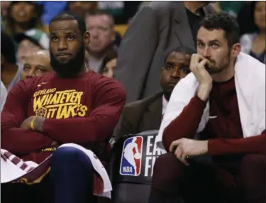  ?? MICHAEL DWYER — ASSOCIATED PRESS ?? LeBron James and Kevin Love watch from the bench during the fourth quarter of the Cavs’ Game 1 loss to the Celtics.