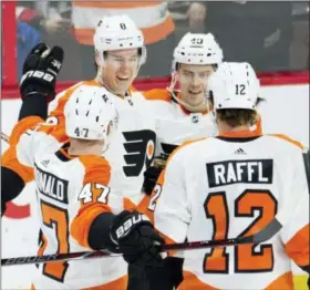  ?? ADRIAN WYLD — THE CANADIAN PRESS VIA AP ?? Philadelph­ia Flyers defenseman Robert Hagg (8) celebrates his goal with teammates Andrew MacDonald (47), Jordan Weal (40) and Michael Raffl (12) during first period NHL action Saturday in Ottawa. The Flyers defeated the Senators 5-3.