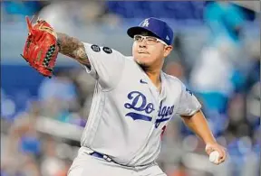  ?? Wilfredo Lee / Associated Press ?? Julio Urias of the Dodgers delivers a pitch against Miami. Urias allowed five hits and one run in seven innings Thursday to pick up the victory.
