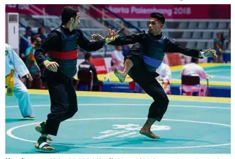  ?? — AFP ?? Here it comes: Malaysia’s Mohd Al-Jufferi Jamari (right) competing against Iran’sAkbar Kiyaniyan during the Putra E (65-70kg) quarter-finals on Friday.