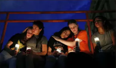  ?? John Locher/ Associated Press ?? From left, Melody Stout, Hannah Payan, Aaliyah Alba, Sherie Gramlich and Laura Barrios comfort each other during a vigil for victims of the shooting on Saturday in El Paso, Texas.