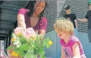  ?? AP ?? People lay flowers at a memorial in Portland, Oregon, for victims of the stabbing attack.