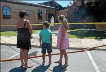  ?? DIGITAL FIRST MEDIA FILE PHOTO ?? Rita Tomassian of Glenolden stopped by Our Lady of Angels Regional School with her grandchild­ren Justin, 7, and Samantha, 11, last Thursday after the fire.