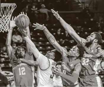  ?? Travis Heying / Associated Press ?? Wichita State’s Alterique Gilbert, center, was part of a Shockers trio that combined for 44 of Wichita State’s 68 points and seven 3-pointers. Gilbert and Tyson Etienne each finished with 16 points for Wichita State.