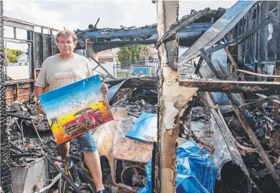  ?? Pictures: JERAD WILLIAMS ?? Artist Greg McDonald was able to salvage this painting but little else after fire destroyed his Benowa home on Saturday night.