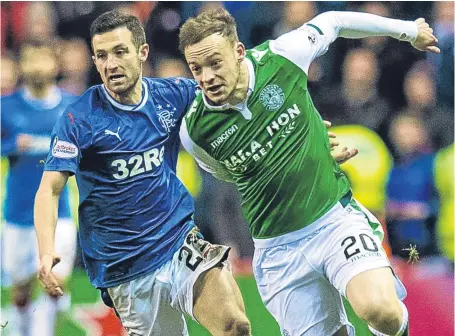  ?? SNS. ?? Jason Holt keeps a close eye on Hibs dangerman Brandon Barker during Wednesday’s Easter Road clash.