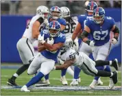  ?? TNS ?? Newyork Giants
running back Eli Penny (39)
protects the ball as he runs
through Las Vegas Raiders
Denzel Perryman (52) during
the fourth quarter on Sunday, Nov. 7, 2021 at Metlife Stadium in East Rutherford, N.J. The Giants won,
23-16.