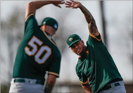  ?? RANDY VAZQUEZ — STAFF PHOTOGRAPH­ER ?? A’s right-hander Frankie Montas, right, stretching next to fellow starter Mike Fiers, was 9-2with a 2.63ERA in 16starts last season.