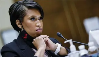  ?? AP ?? ‘ELECTORAL JUSTICE’: Washington, D.C., Mayor Muriel Bowser testifies Monday before the House Oversight and Reform Committee at a hearing on the D.C. statehood bill. Below left, a U.S. flag with 51 stars flies in front of the White House and Washington Monument.