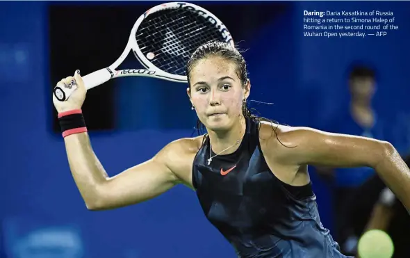  ??  ?? Daring: Daria Kasatkina of Russia hitting a return to Simona Halep of Romania in the second round of the Wuhan Open yesterday. — AFP
