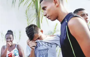  ?? Reuters ?? People wait for informatio­n at the training centre of the football club Flamengo, after a deadly fire in Rio de Janeiro yesterday morning.