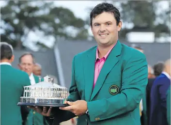  ?? DAVID CANNON/GETTY IMAGES ?? Patrick Reed celebrates with his trophy during the green jacket ceremony after winning the 2018 Masters by one stroke on Sunday in Augusta, Ga.