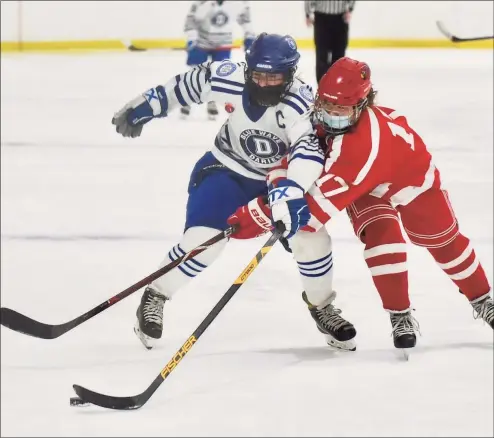  ?? David Stewart / Hearst Connecticu­t Media ?? Darien’s Nelle Kniffin, left, and Greenwich’s Emiri Fukichi battle for the puck during the FCIAC girls ice hockey semifinals on Thursday at the Darien Ice House.