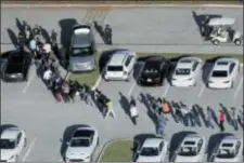  ?? ASSOCIATED PRESS ?? Students are evacuated by police from Marjory Stoneman Douglas High School in Parkland, Fla., after a shooter opened fire on the campus on Feb. 14.