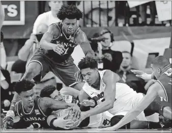  ?? [TONY GUTIERREZ/THE ASSOCIATED PRESS] ?? A scrum breaks out for a loose ball between Kansas and Baylor players during the first half Saturday in Waco, Texas.