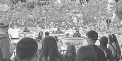  ?? EVE CHEN/USA TODAY ?? Guests wait their turn for a spin on Mad Tea Party at Disneyland.