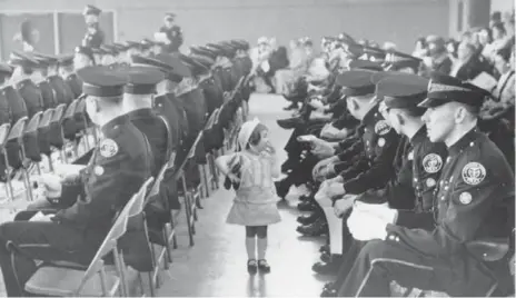  ?? REG INNELL PHOTOS/TORONTO STAR FILE PHOTOS ?? This photo of a 2-year-old girl searching for her father during a police graduation ceremony in Toronto won Innell a National Newspaper Award in 1967.