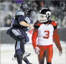  ?? Ryan Remiorz ?? The Canadian Press Toronto Argonauts kicker Lirim Hajrullahu catches leaping teammatee Cody Fajardo (17) after hitting the decisive field goal in the CFL championsh­ip game as Calgary Stampeders defensive back Patrick Levels (3) leaves the snowy field...
