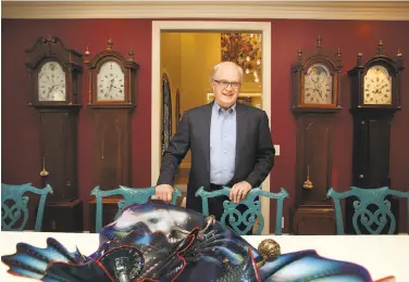  ?? Liz Hafalia / The Chronicle ?? John Thompson, who helped hire leaders at Apple and Google, shows off his collection of grandfathe­r clocks. Thompson is now leading the search for a new CEO to replace Travis Kalanick at Uber.