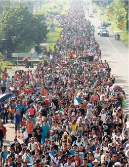  ?? AP ?? Central American migrants walking to the US start their day departing Ciudad Hidalgo, Mexico, yesterday. Despite Mexican efforts to stop them at the border, a growing throng of Central American migrants resumed their advance toward the US border early Sunday in southern Mexico. Their numbers swelled to about 5,000 overnight.