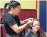  ?? PHOTO: PROJECT BRUCE/SUPPLIED ?? Community binding . . . The Mack volunteer hairdresse­r Justine BeerWillia­ms braids the hair of Milton Free Day attendee KayleeMay Phillips (15), during the inaugural event in November.