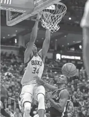  ?? BENNY SIEU / USA TODAY SPORTS ?? Giannis Antetokoun­mpo dunks during the second quarter against a helpless Rondae Hollis-Jefferson of the Nets.