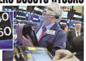  ?? AP PHOTOS ?? BIG GAINS: A trader works on the floor of the New York Stock Exchange yesterday. Stocks rose sharply as the market made up some of its huge losses from last week.