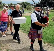  ??  ?? The funeral for popular Waikanae goose Thomas on Saturday was a community affair, complete with coffin and bagpiper.