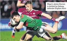  ??  ?? Mayo’s James Durcan is tackled by Galway defender Eoghan Kerin