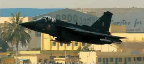  ??  ?? A “clean” Tejas bearing only ACMI pods blasts past hangars at HAL Bangalore