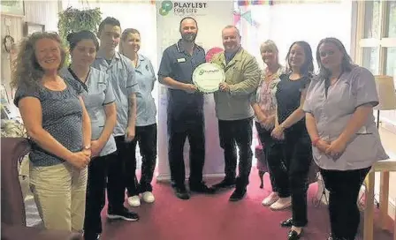  ??  ?? Well done Craigielea Care Home staff receive the Playlist for Life accreditat­ion