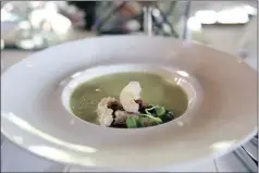  ??  ?? Pea soup with chorizo and pork puffs served with Haute Cabriere Chandonnay Pinot Noir.