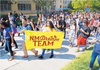  ?? MARLA BROSE/JOURNAL ?? Jorge Guerrero and Anacaren Ruiz carry a banner supporting immigrants as they march around the University of New Mexico campus Tuesday with hundreds of students, staffers and faculty members.